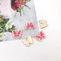Macro detail of pink enamel butterfly pendants with golden alloy frame for DIY jewelry - 11mm / Rose Red