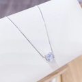 Elegant silver cylinder necklace with micro-pave zircons on a white leather display stand - Silver