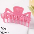 Close-up of bright pink translucent geometric hair claw clip with strong teeth and matte finish - Pink / 9.5CM