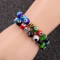 Colorful natural gemstone bead bracelets with metal Buddha head charms on model - Multicolor Set