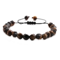Detailed macro view of faceted yellow tiger eye stone beads on a black braided cord - Faceted Tiger Eye