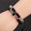 Stackable beaded bracelet set with black and multicolor stone beads on model's wrist - Black Beaded Bracelet And Colored Ore Bracelet
