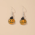 Quirky Halloween orange pumpkin drop earrings with black evil face on skin tone background - Orange Large Pumpkin