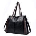 Large black leather tote bag with brown straps and pebble texture in a side view - Black