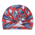 Close-up of printed turban hat with chain and leopard patterns and front twist detail - Red and Light Blue