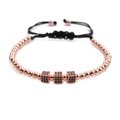 Detail of rose gold bracelet with black zircon cubes and adjustable woven cord strap - Rose Gold 3 Cubes