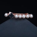 Rose gold hair clip with white pearls and black clover charm on textured background - 08# Clover Pearl Style