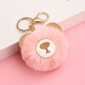 Detailed close-up of pink fluffy bear ear keychain with golden clasp and embroidered tree - Korean Pink