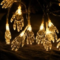Warm white LED Halloween string lights with transparent skull hand shaped decorations - Ghost Hand