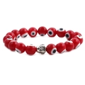 Detailed view of red evil eye beads and vintage silver Buddha charm on elastic bracelet - Red Eye Platinum Buddha Head