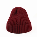Macro detail of wine red cable knit texture and ribbed cuff on a warm winter beanie - Burgundy