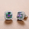 Macro detail of square cut rainbow halo stud earrings with silver claw setting and cubic zirconia - Colorful