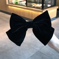Elegant large black velvet bow hair clip shown in hand for a classy aesthetic style - Duckbill Hair Clips / Large (18cm) / Black