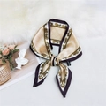 Elegant beige polyester silk scarf with burgundy border tied in a bow on plush fabric - Chain Print Khaki