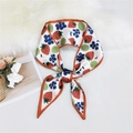 White silk scarf with fruit print and orange edges, styled in a bow on a white desk - Strawberry Fruit