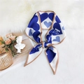 Blue and white silk scarf with large heart pattern and brown edges on white plush surface - Blue Heart Carriage Pattern