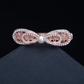 Elegant rose gold rhinestone bow hair clip with a central pearl accent on dark surface - 12# Bowknot