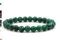 Green malachite beaded bracelet with black wave patterns on polished round tiger eye stones - Malachite