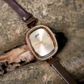 Vintage gold square watch with crystal bezel and brown leather strap on nature background - Brown