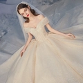 Sparkling champagne off-shoulder ball gown wedding dress with sequin detail and long train - US 10 / Floor Length / Champagne