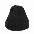 Close-up of black cable knit beanie showing thick ribbed texture and soft fabric - Black