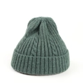 Detail of dark green cable knit beanie showing thick texture and folded cuff edge - Dark Green