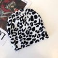 Close-up of black and white leopard print knit beanie texture and animal pattern detail - Leopard Print