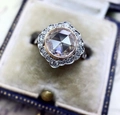 Macro detail of a vintage rose gold ring with moissanite stones in a luxury blue jewelry box - Cy777 / Size 5