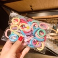 Colorful elastic hair ties in a transparent pouch featuring a small daisy print - 50 Pcs Bag / Colorful