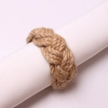 Handcrafted natural jute rope napkin ring featured on a white fabric napkin - Hemp Rope Woven