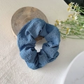 Elegant navy blue organza scrunchie with textured fabric on a rustic wooden stand - Bubble Dark Blue
