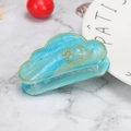 Close-up of blue marble resin cloud hair claw with golden star and moon patterns - Starry Sea Blue Moon
