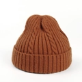 Detail of dark brown cable knit beanie showing thick rib texture and warm braided pattern - Caramel color
