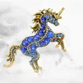 Vintage unicorn brooch with blue crystals and antique gold finish in a leaping pose - Gold Plated Blue Zirconia
