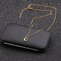 Macro shot of gold-plated necklace with a G letter pendant on a black textured box - Gold G