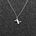 Macro detail of silver stainless steel letter X pendant on a fine link chain necklace - Steel X