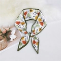 Narrow silk scarf with yellow and orange floral patterns on white background tied as a bow - Autumn Leaf Green