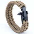 Detail of khaki survival bracelet with a durable black metal shackle on white background - Gray