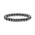 Deep metallic gray hematite beaded bracelet with polished tiger eye stones on white base - Hematite