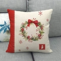 Christmas wreath linen pillowcase with red ribbon and snowflake details on a gray sofa - Style 33
