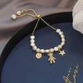 Baroque pearl bracelet with gold teddy bear charm and adjustable sliding clasp closure - Bear Charm Style / White/Gold