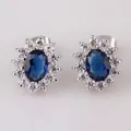 Classic sunburst stud earrings with oval deep blue sapphire-style stone and white zircons - Stud Earrings / Blue