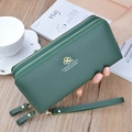 Dark green long wallet with lychee pattern texture and double zippers in hand - Green