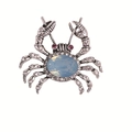 Sparkling crab brooch with a blue opal center and clear rhinestones on a silver base - Silver Tone Iridescent Light Blue Gemstone