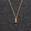 Detailed view of golden stainless steel necklace with polished letter I pendant - Gold I