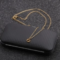 Macro shot of a golden letter pendant necklace on a black woven texture jewelry box - Gold O