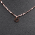 Close-up of a minimalist rose gold stainless steel necklace with a hollow oval pendant - Rose Gold O