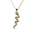 Detail of gold snake pendant necklace featuring clear zircons and green gemstone eyes - 0181 Snake Style 1 Box Chain Gold