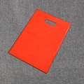 Flat red plastic shopping bag with die-cut handle on grey textured background - 15*20cm / Red