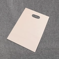 Single light pink PE flat plastic gift bag with punched handle on gray fabric texture - 15*20cm / White
